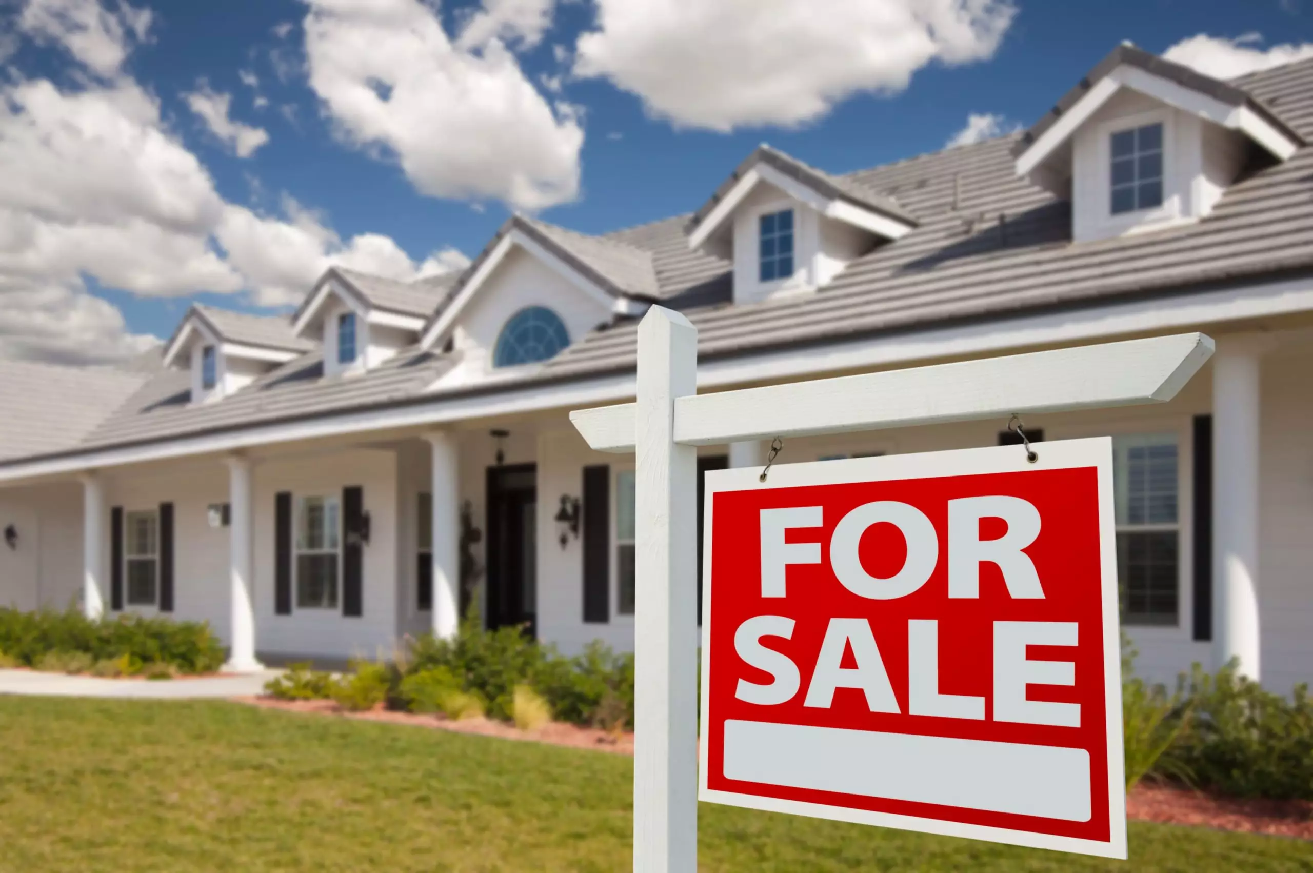 Home For Sale Real Estate Sign in Front of New House - Right Facing